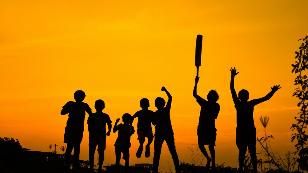 Silhouette Of Kids Playing Cricket